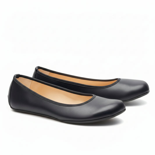 Ein Paar schwarze QARMA-Ballerinas von ZAQQ im schwarzen Ballerina-Design mit abgerundeter Spitze und hellbraunem Fußbett-Innenleben, nebeneinander vor weißem Hintergrund präsentiert.